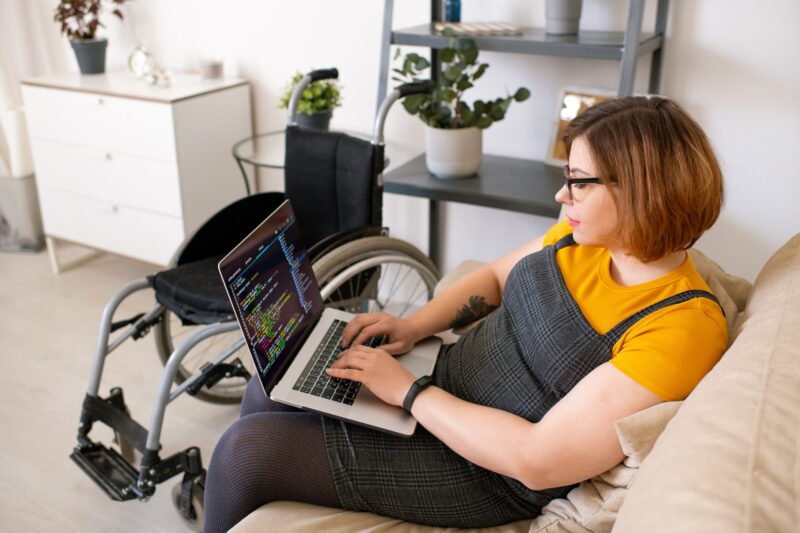 Disabled woman coding at home