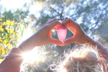 Woman holding a menstrual cup
