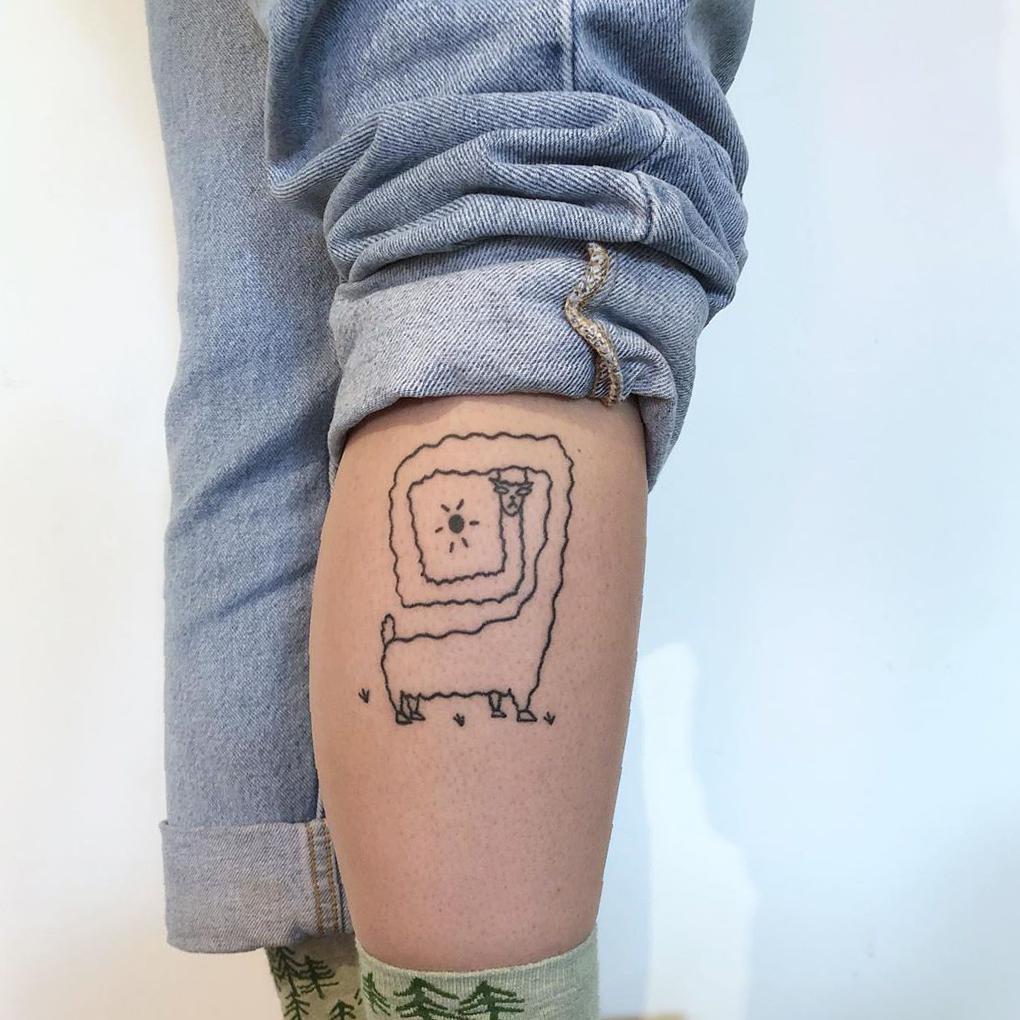 female calf tattoo